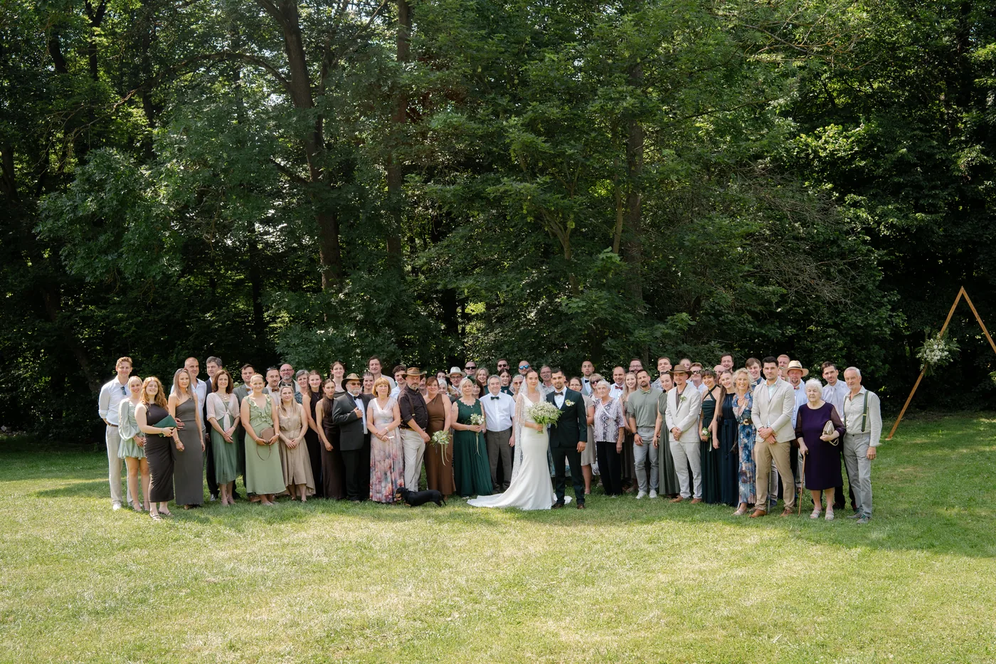 The whole wedding party photographed together in the orchard