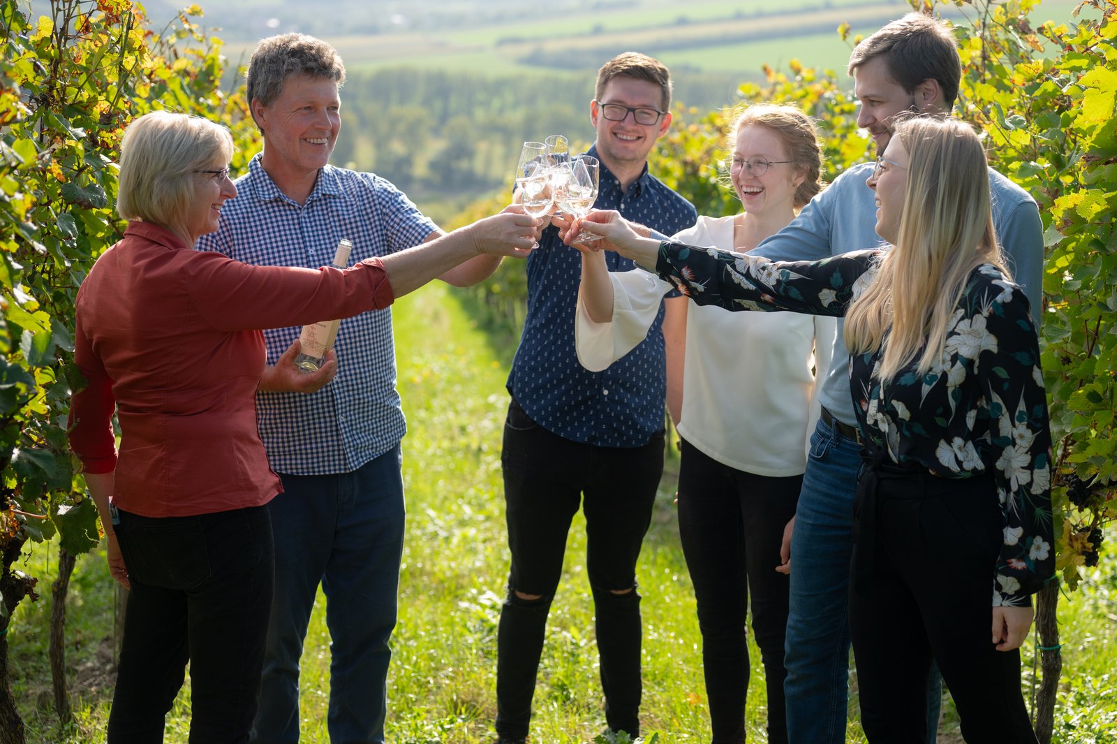 The Kadubec family and friends raising glasses among the vines above Lipov.