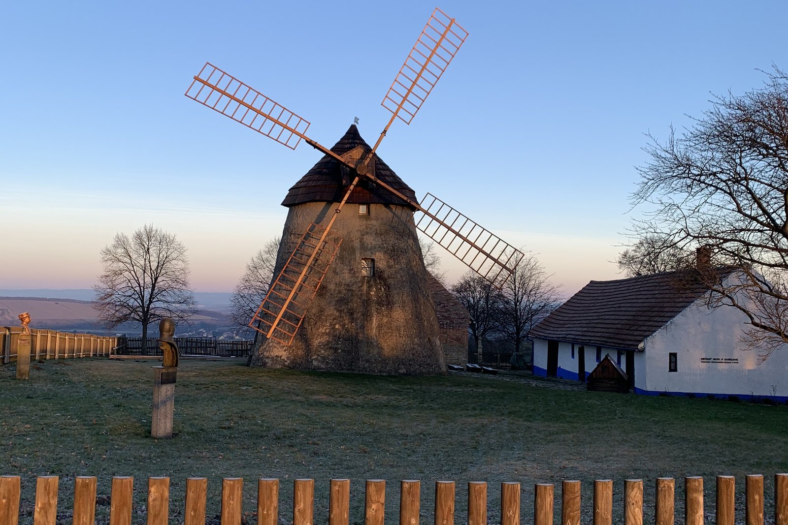 The 1842 windmill above Kuželov on a frosty winter morning, with the miller's house beside it.